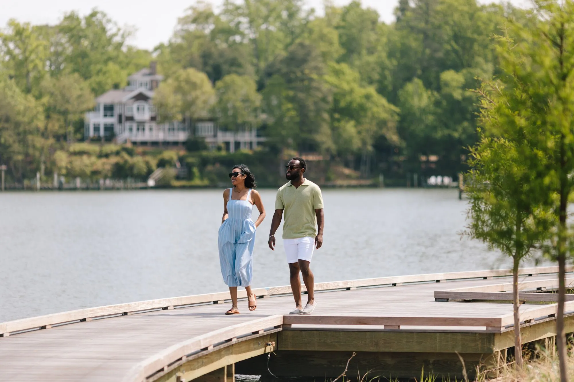 Two guests walking along the boardwalk by the waterfront at our waterfront hotel in Irvington, VA